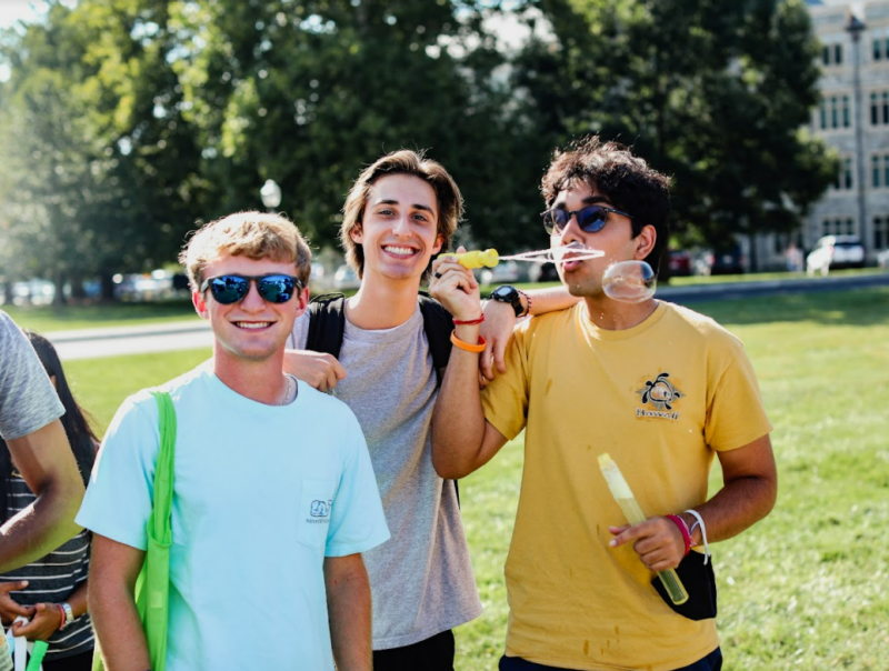 Students blowing bubbles on campus